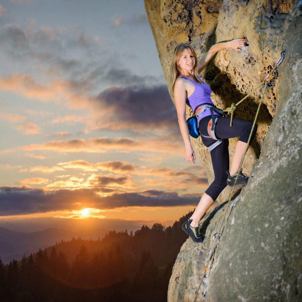 female-climber-climbing-with-rope-on-a-rocky-wall-1-e1695355009793.jpg