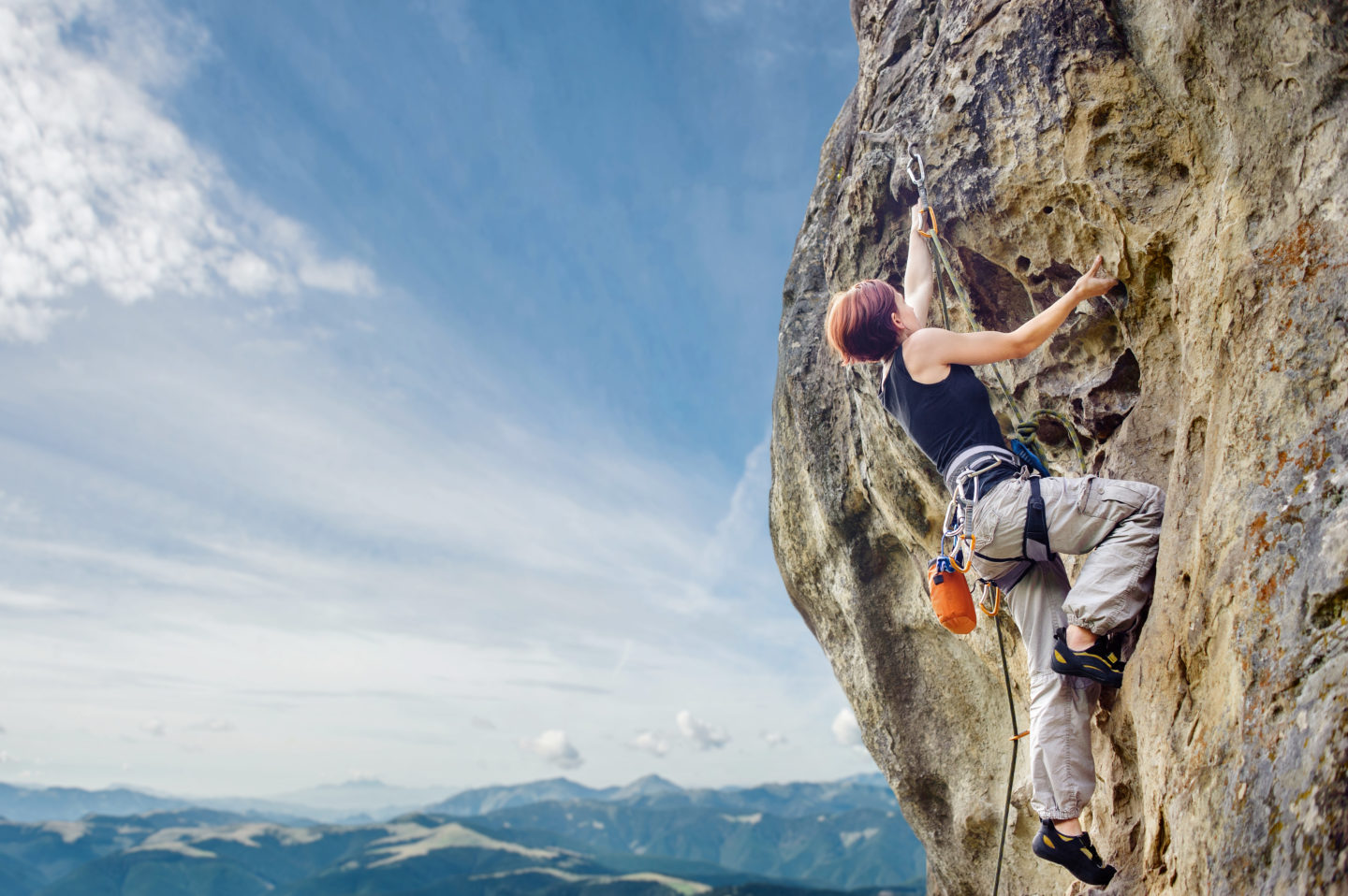 female-rock-climber-on-steep-overhanging-rock-cliff-2-e1695354936110.jpg