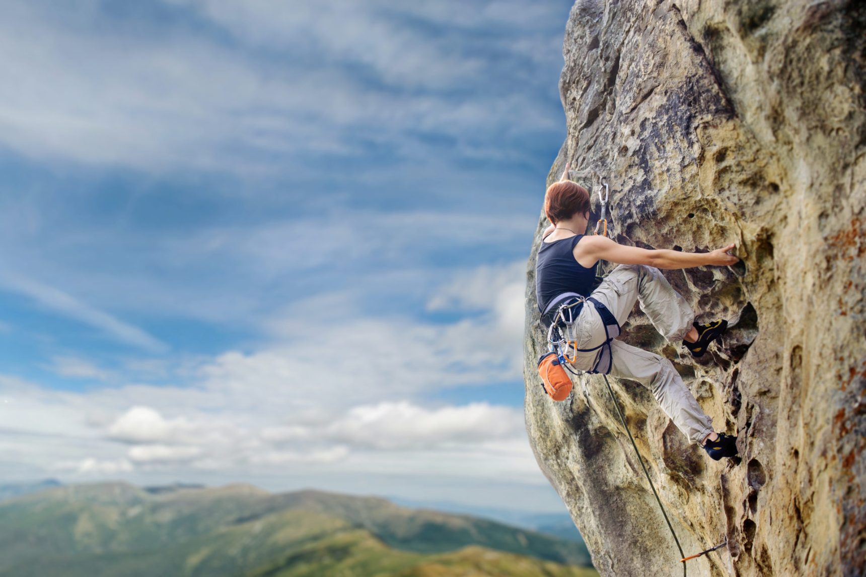 female-rock-climber-on-steep-overhanging-rock-cliff-e1695732068782.jpg