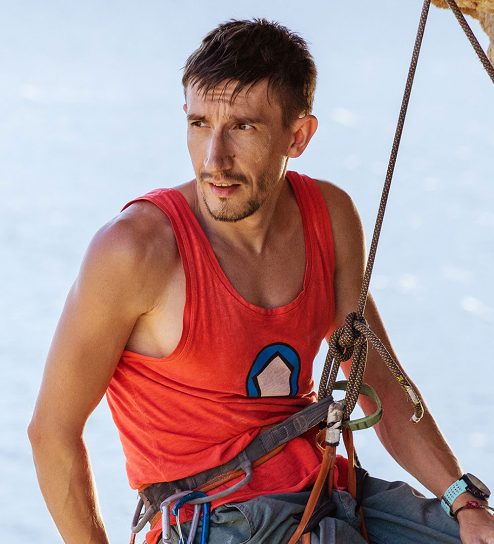 male-rock-climber-resting-while-hanging-on-rope-PTEPG3U.jpg