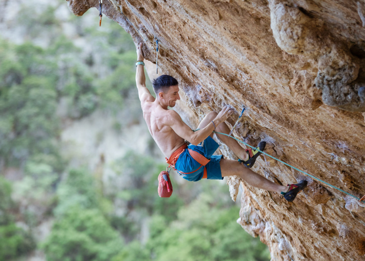 rock-climber-on-challenging-route-on-overhanging-cliff-e1695288220836.jpg
